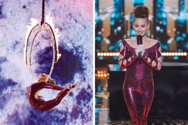 Sofie Dossi contorting her left leg over her shoulder while pulling her hair back.